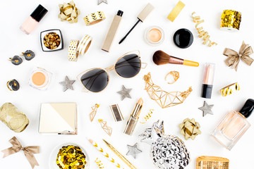 Cosmetics collage with lipstick, brush and other accessories on white background. Composition in gold colors. Flat lay, top view.