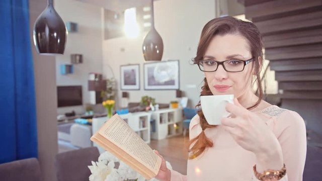 Pretty, calm woman holding a cup of coffee