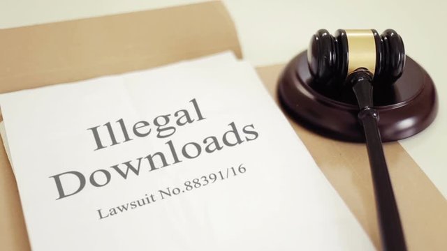 illegal downloads lawsuit documents with gavel placed on desk of judge in court