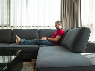 Man using laptop in living room