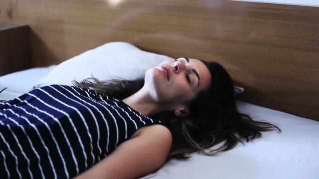 woman fall on bed