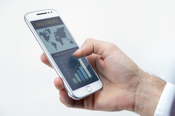 Business Man´s smartphone with a investment web page on the screen. Investment graphics, bar graphics, world investments, marketing, ecommerce, web page through a cell phone, responsive web design.