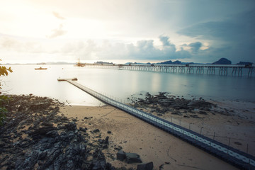 beach with bridge in long exposure