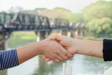 Closeup hands with tourists in a friendly woman with a background rail travel.