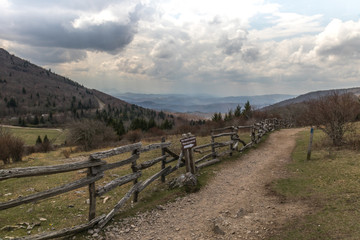 Fototapeta na wymiar Mountain View from a Fence Lined Hiking Trail 