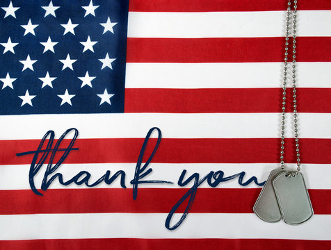 word thank you and military dog tags on American flag