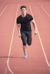 Obraz premium one young man running, red running tracks