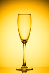 Empty wine glass on yellow background