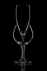 Group of empty wine glasses on black.