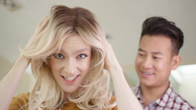  Transvestite man getting dressed shares a kiss with his partner