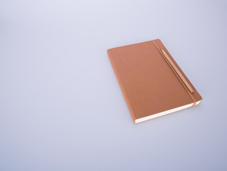 notebook or leather diary and pencil on the blackground.