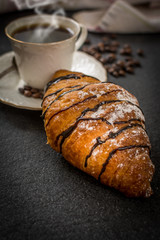 Croissant with chocolate and coffee