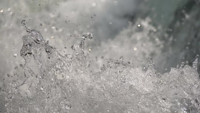 Slow motion water floating down a cascade of a river, close, in 4K
