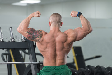 Man Showing His Well Trained Body In Gym