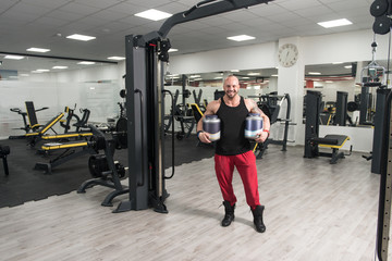 Bodybuilder Posing With Supplements For Copy Space