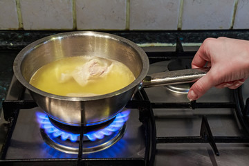 Cooking chicken broth on gas stove
