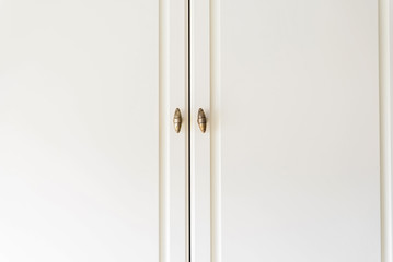 Close-up white cupboard wooden doors
