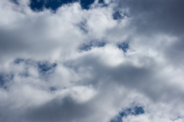 Evening clouds on the background of the blue sky.