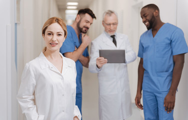 Young charming nurse standing in the hospital