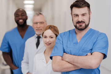 Mature practitioner expressing joy in the hospital