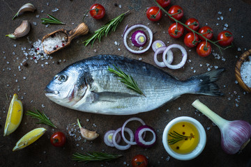 Fototapeta na wymiar Dorado and ingredients for cooking. Fresh fish. Top view.