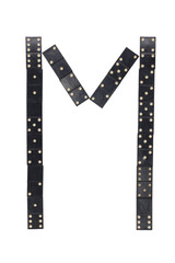 letter M made of  black  dominoes tiles