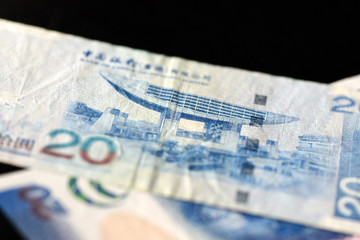 Two bills of twenty Hong Kong dollars on a dark background