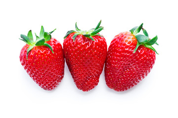Three ripe red strawberry on a white background. Isolated