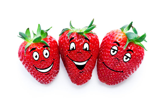 Ripe red strawberries with emotions on the faces on a white background. Isolated