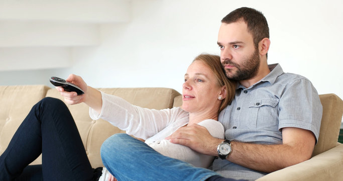 Senoior Couple Watching Tv In Modern Villa