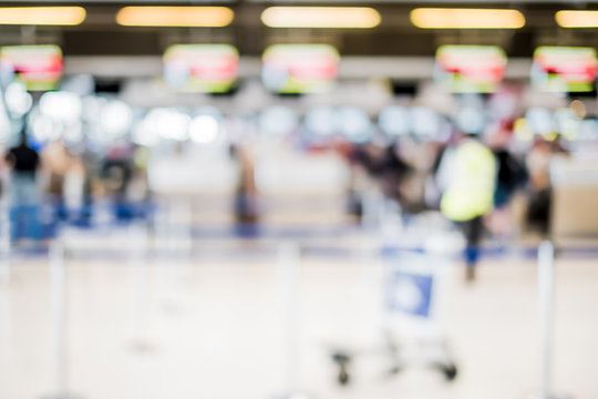 Blurred background,Traveler with baggage at Terminal Departure Check-in at airport with bokeh light