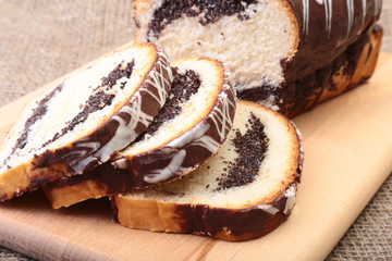 Fresh baked homemade sweet pies, strudel with poppy-seed filling on wooden board.