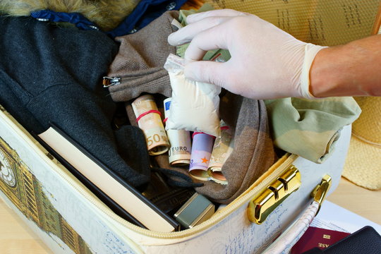 Suitcase with money and drugs on custom inspection