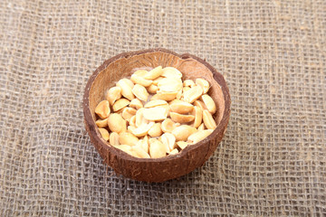 Roasted peeled peanuts in Handmade bowl of coconut, Selective Focus