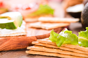 Crackers with ham and avocado. 