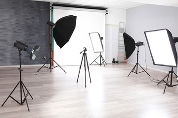 Empty photo studio with lighting equipment