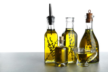 Olive oil with herbs, isolated on white