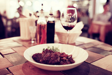 Serving a glass of red wine in a restaurant
