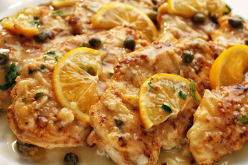 Delicious Italian chicken piccata with lemon slices, closeup