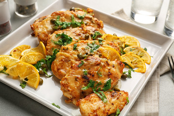 Tasty Italian chicken piccata with lemon on plate