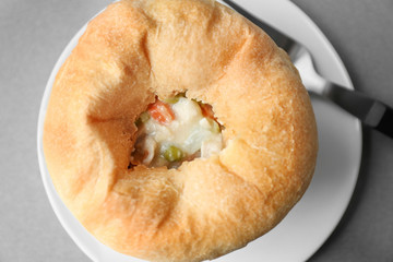 Plate with tasty chicken pot pie on grey table