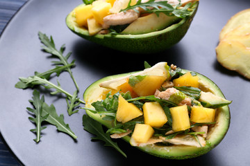 Plate with chicken salad in boats from avocado, closeup