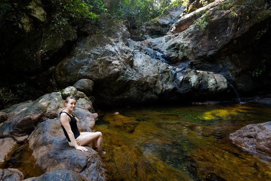 Beautiful women swimming in waterfall
