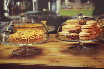Stands with tasty sweets on table in cafe