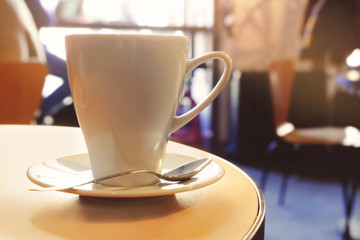 Cup of coffee on table in cafe