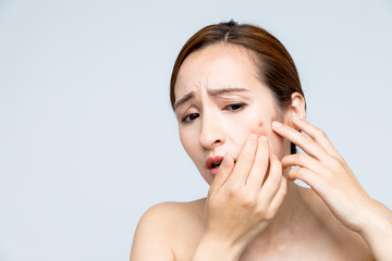 beautiful woman who checks her skin, skin care, acne treatment