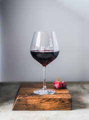 Glass of wine on wood cutting board