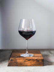Glass of wine on wood cutting board