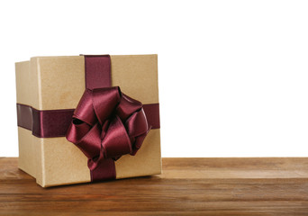 Beautiful gift box with vinous ribbon and blank label on wooden table
