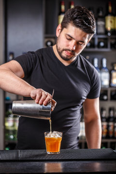 Barman pouring alcohol